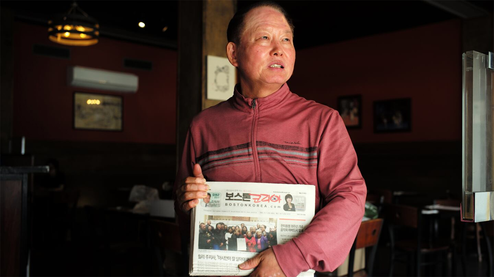 Jeff Lee, owner of Seoul Jangteo, with copies of The Boston Korea newspaper. Credit: Jonathan Wiggs/ Globe Staff